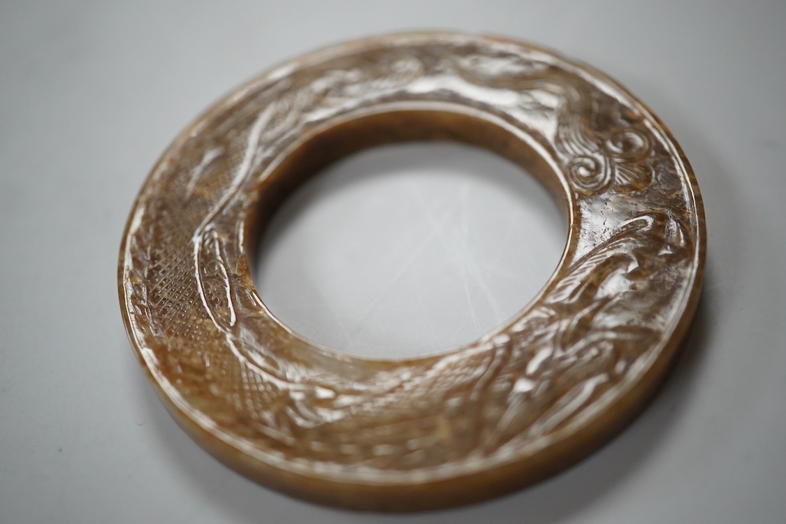 A Chinese russet jade dragon disc, 5.5cm diameter